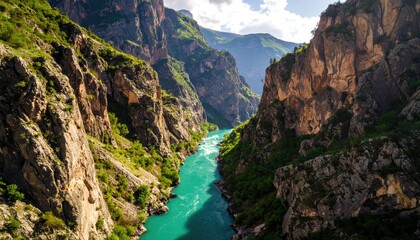 Obraz premium Mountain river gorge with rocky cliffs and emerald water
