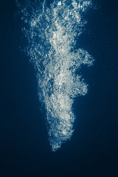 underwater splash bubbles in blue water environment