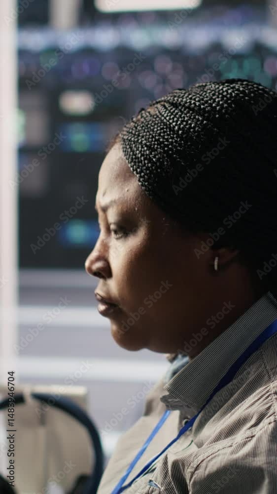 Poster vertical video data center system administrator using pc to monitor neural network ai visualization.