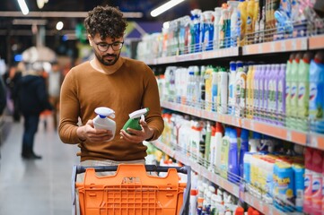 Man choosing cleaning products in supermarket