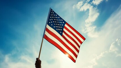 Hand holding American flag against blue sky for national holidays, educational projects, and patriotic event promotions – red, white, blue palette - Powered by Adobe
