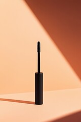 Black mascara wand against peach backdrop (1)