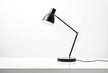A black table lamp on a white surface.