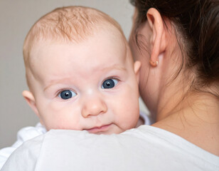Closeup captures tender gaze of baby, its eyes wide with fascination, reflecting moment of connection