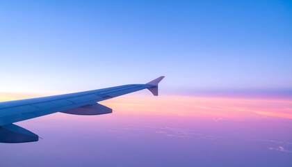 Fototapeta premium Airplane wing view at sunrisesunset.