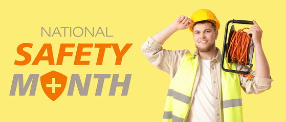 Male contractor with extension cord reel on yellow background