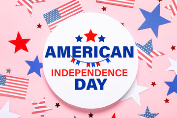 Composition with blank card, USA flags and stars on pink background. Independence Day celebration