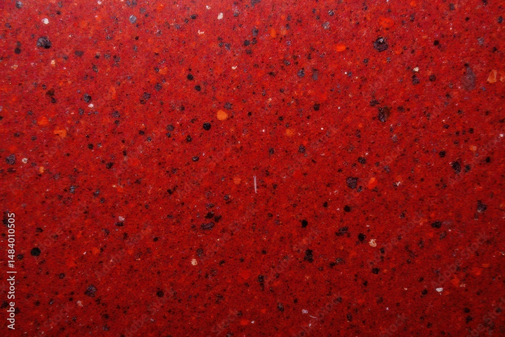 Poster textured red surface with black and white speckles for design