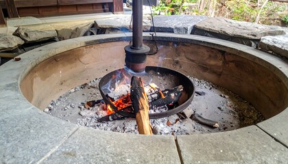Fire pit burning wood outdoors.