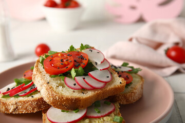 Plate with delicious radish bruschettas on white tiled table