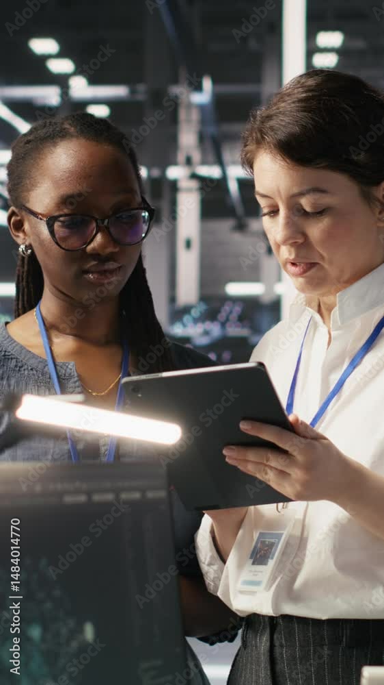 Poster vertical video teamworking engineers in data center integrate ai automation tools together during ma