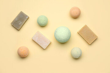 Bath bombs with soap bars on beige background