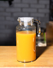 Glass Jar of Fresh Orange Juice on Table.