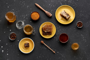 Sweet honey, combs and bee pollen on black background