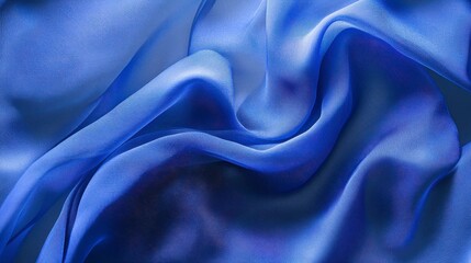 Fototapeta premium Abstract blue silk fabric texture with soft waves and folds.