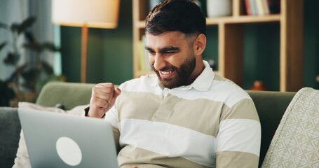 Man, fist pump and laptop on sofa with celebration, excited and winning with online giveaway in home. Person, computer and happy with goals, success and profit with investment in living room at house