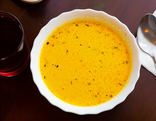 Popular dish of Russian cuisine is an appetizing cheese soup prepared with the addition of onions, carrots and potatoes in ..chicken broth