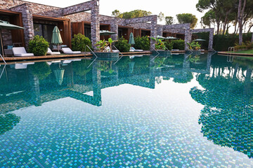 Outdoor swimming pool with umbrellas and sunbeds at resort