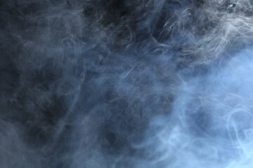 Beautiful smoke in lights on dark background