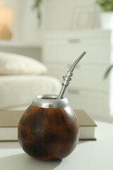 Traditional yerba mate tea on white table indoors