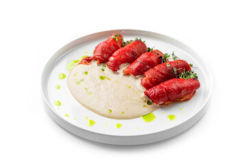 Baked roasted red pepper with cheese sauce on plate isolated on white background. Healthy food, close up, top view