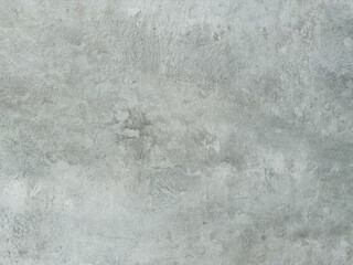 Detailed close-up of a textured light grey surface resembling aged concrete or plaster with subtle variations and marks, perfect for backgrounds