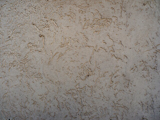 Textured Beige Plaster Wall with Subtle Patterns