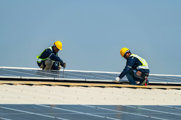 Two engineers install solar panels on a rooftop, wearing safety gear and helmets. The scene showcases renewable energy, green technology, and sustainable solutions under a clear blue sky.
