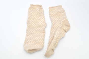 beige socks with a small white square pattern on a white background