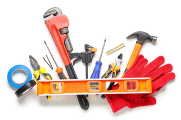 Gloves and construction tools on white background