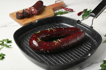 Grill pan with tasty blood sausage on white background