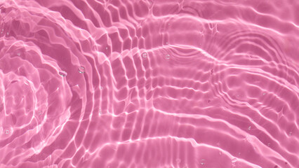  Abstract background of pink water with ripples under sunlight. Top view, flat lay.
