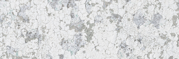 Peeling paint on the wall. Old concrete wall with cracked flaking paint. Weathered rough painted...