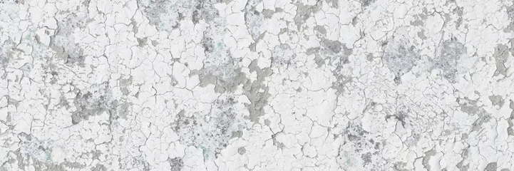 Peeling paint on the wall. Old concrete wall with cracked flaking paint. Weathered rough painted surface with patterns of cracks and peeling. Grunge texture for background and design. High resolution. © Andrei Stepanov