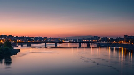 Evening Cityscape View With Bridge Reflection Over Water Under Sunset Sky