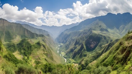 Fototapeta premium Lush green valley with mountains and clouds.