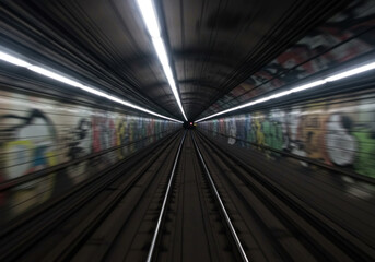 Subway train rushing through tunnel.