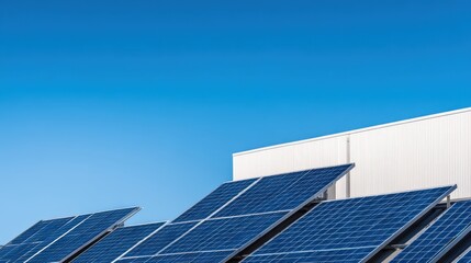 Solar panels installed on a modern building under a clear blue sky, showcasing renewable energy