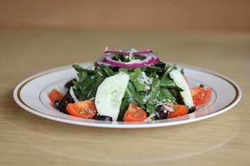 A vibrant garden salad filled with fresh vegetables and topped with onions and olives, highlighting the beauty and healthiness of wholesome ingredients in a meal.