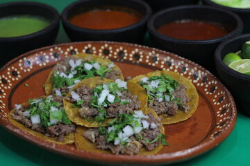 A vibrant plate featuring traditional tacos filled with seasoned beef, topped with onions and cilantro, showcasing the essence of authentic Mexican cuisine.