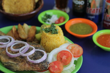 A beautifully presented grilled fish dish accompanied by rice and fresh vegetables, showcasing a healthy and colorful meal that appeals to seafood lovers everywhere.