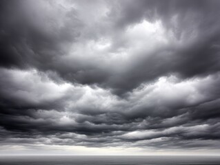 Obraz premium Dark, dramatic storm clouds gather over a calm, expansive sea, creating a moody and atmospheric scene.