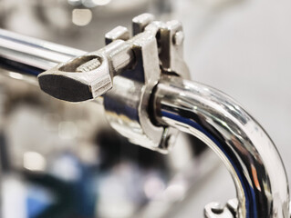Close-up view highlighting intricate details of polished metal machinery in an industrial setting...