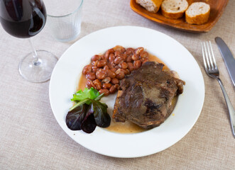 Delicious juicy fried pork belly with beans and stewed carrots