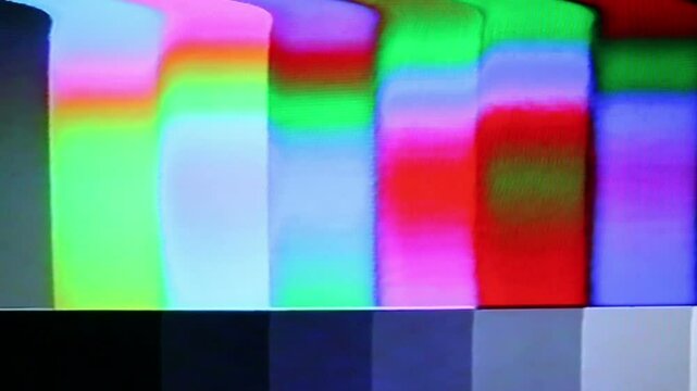 Color bars test pattern through authentic analog distorted vhs signal. Videotape or film damage.