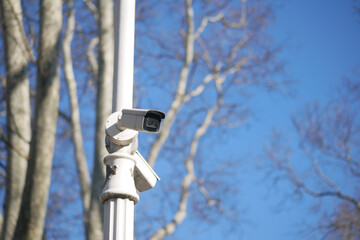 Security camera mounted on pole in clear sky