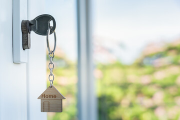 unlocking house is plugged into the door. Second hand house for rent and sale. keychain is blowing...