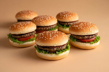 Six delectable hamburgers arranged attractively on a beige surface.
