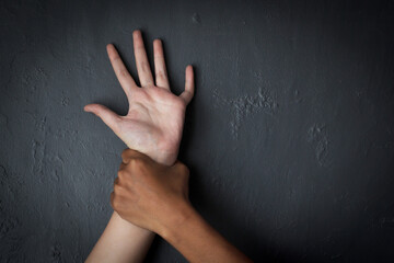 Angry Male Hand Holding A Woman Hand Over Grey Background