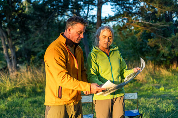 Man and woman exploring the wilderness with a map